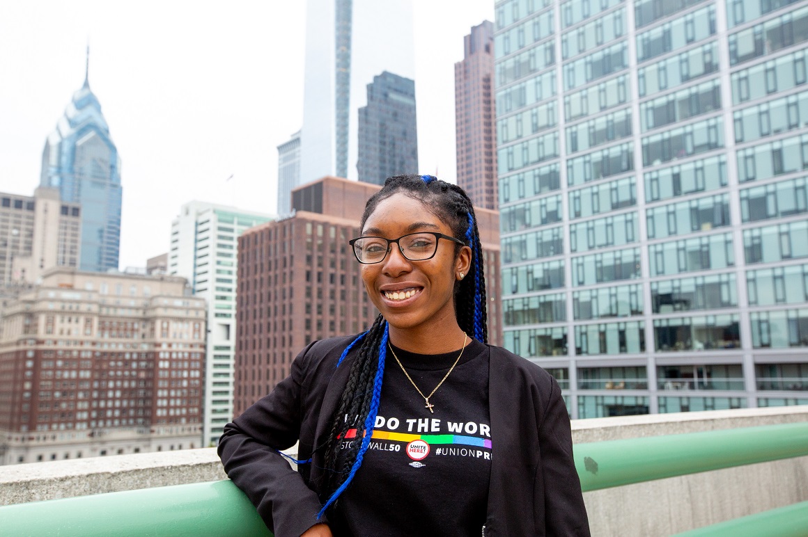 Student smiling with philly skyline
